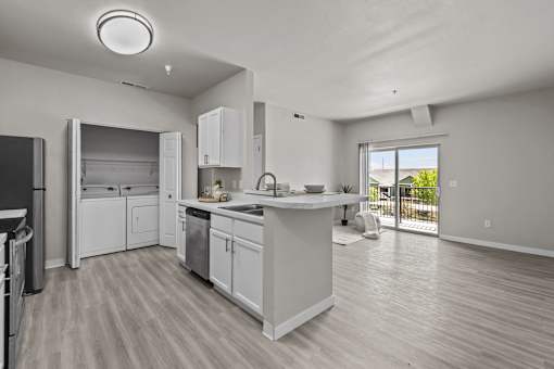 A modern kitchen with white cabinets and appliances.