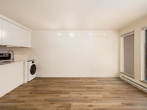 A room with a washing machine and a window.