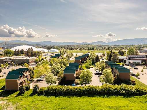 A large green field with a building in the distance.