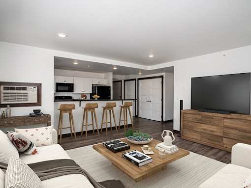 A modern living room with a white sofa, a wooden coffee table, and a kitchen area in the background.