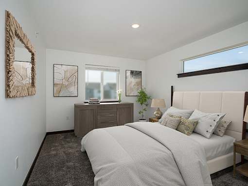 A bedroom with a large bed and a mirror on the wall.