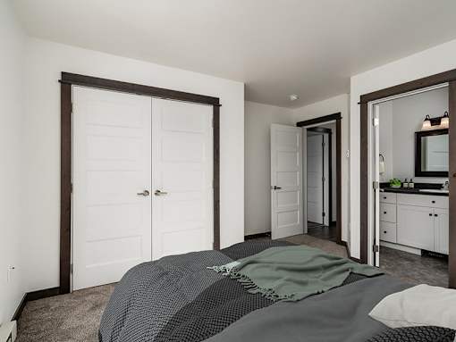 A bedroom with a bed, dresser, and mirror.