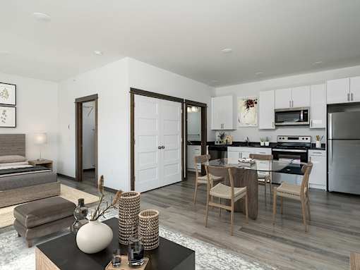 A modern kitchen with a dining table set for two.