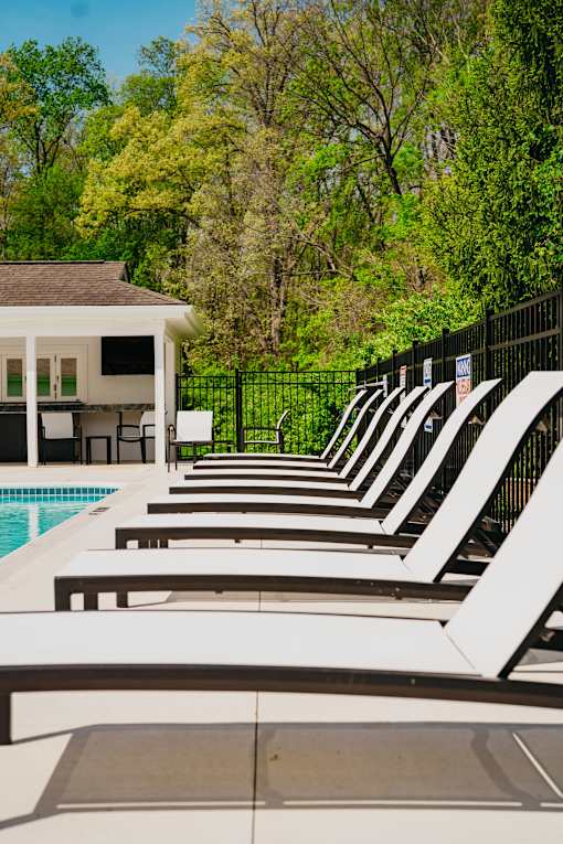 A poolside area with sun loungers and a pool.
