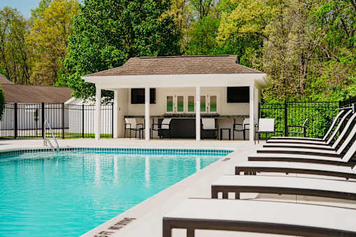 A pool with a gazebo in the background.