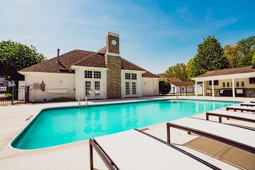 A large house with a pool in front.