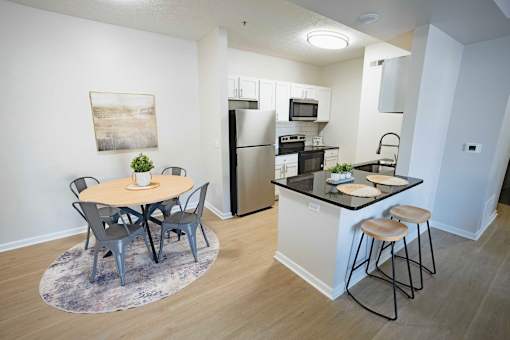 A kitchen with a table and chairs in the middle of the room.