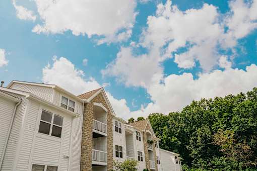 Apartment building with trees in the background.