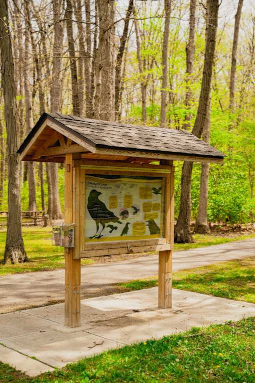 A small wooden shelter with a mural of a bear and cubs on it.
