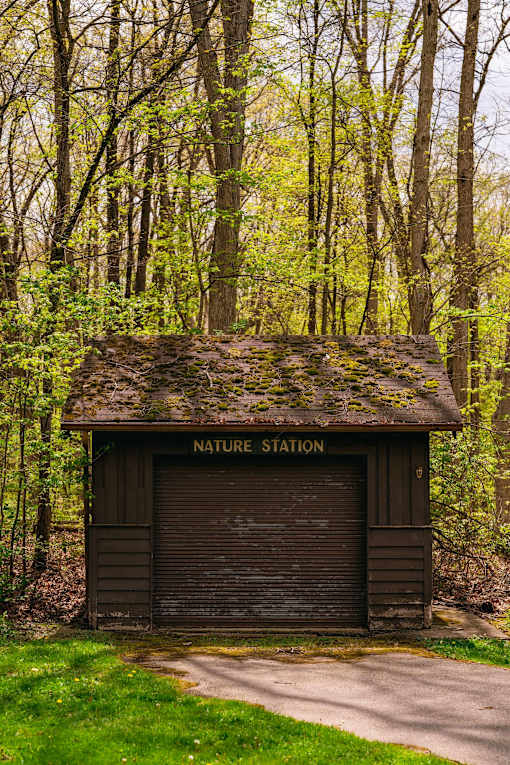 A small brown building with a Nature Station sign on it.