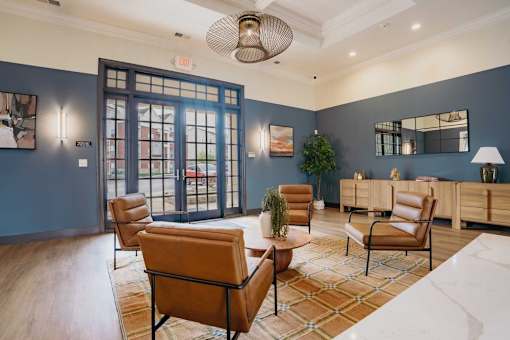 A living room with a brown chair and a white couch.