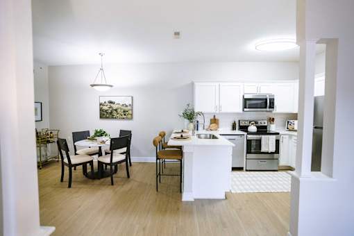 A modern kitchen with a dining table and chairs.