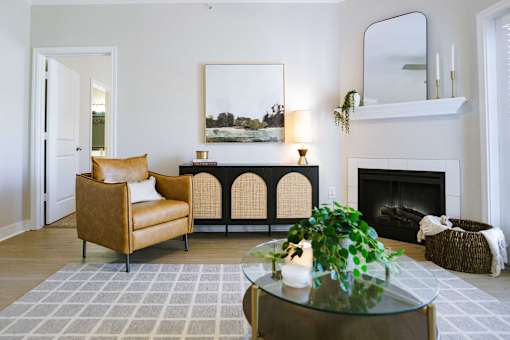 A living room with a fireplace and a painting on the wall.