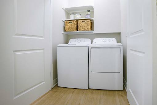 A small laundry room with a washer and dryer.