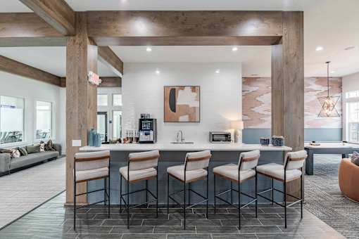 A kitchen with a bar area and a dining table.