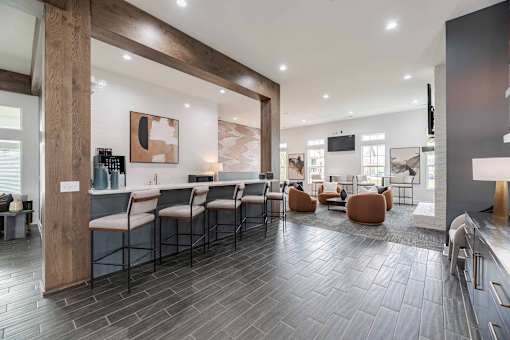 A modern kitchen with a long table and chairs.