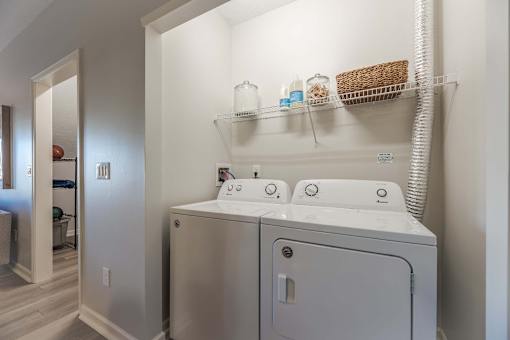 A white washer and dryer in a laundry room.