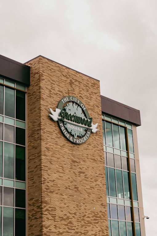 A clock on a building reads 12:00.