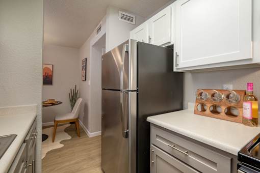 Kitchen with stainless steel refrigerator at Peaks at Sandia View, Albuquerque, New Mexico