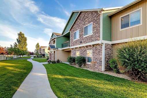 A residential area with houses and a sidewalk.