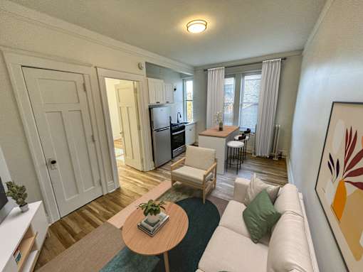 A living room with a white couch and a wooden coffee table.
