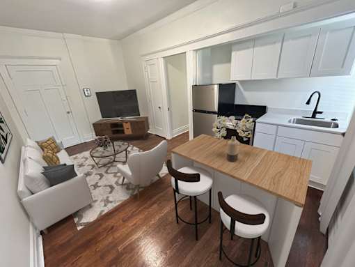 A kitchen with a bar stool and a counter.