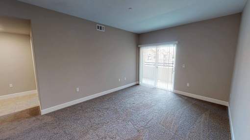 the living room of an empty house with gray walls and a window at Edgewater, Pittsburg, CA 94565  