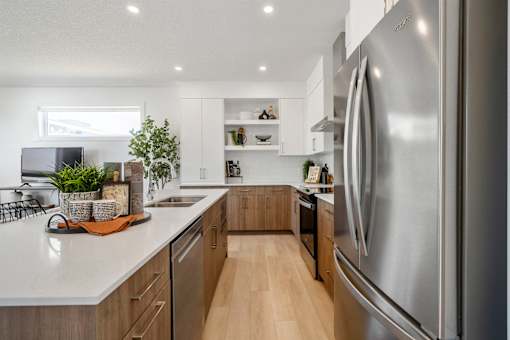 A modern kitchen with a large stainless steel refrigerator.