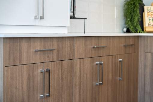 A kitchen with brown cabinets and a white fridge.