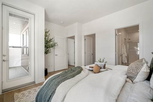 A bedroom with a large bed and a window.