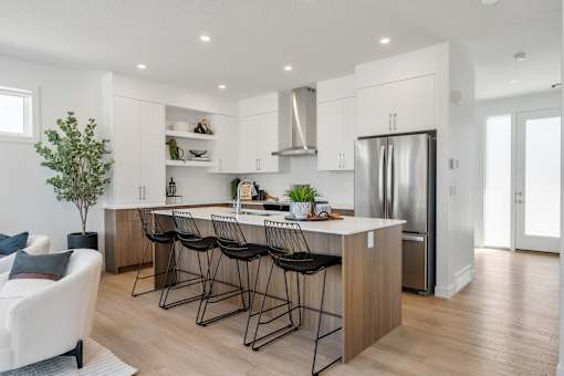 A modern kitchen with a white and wood color scheme.