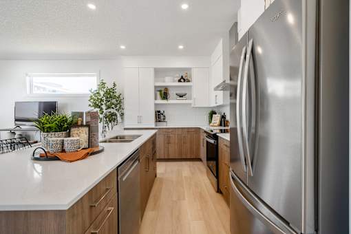 A modern kitchen with a large stainless steel refrigerator.