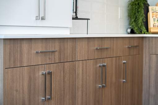 A kitchen with brown cabinets and a white fridge.