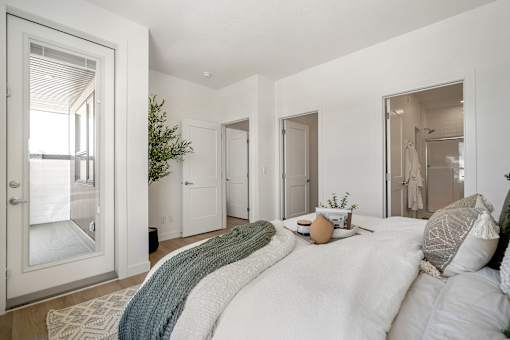 A bedroom with a large bed and a window.