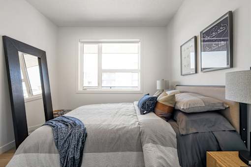 A bedroom with a large bed and a window.