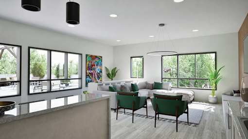 A modern living room with a large painting on the wall and a view of trees outside the windows.