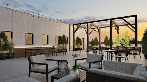 A patio with chairs and tables is set up for an outdoor gathering.