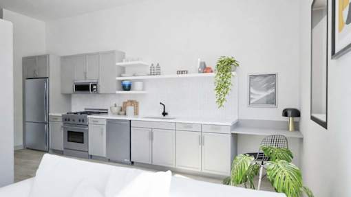 A modern kitchen with white appliances and cabinets.
