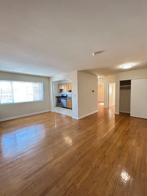 A room with wooden floors and white walls.
