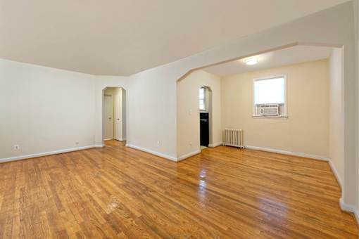 A room with wooden floors and white walls.