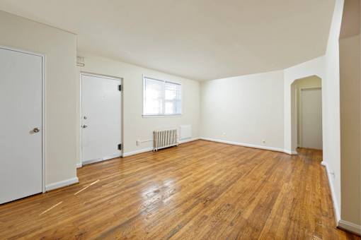 A room with wooden floors and white walls.