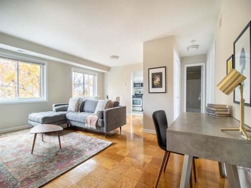 A living room with a grey couch and a grey table.