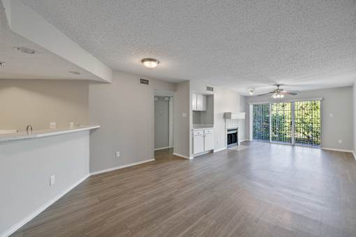 A spacious living room with a fireplace and sliding glass doors.