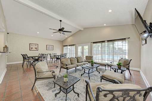 A living room with a fan and a television.