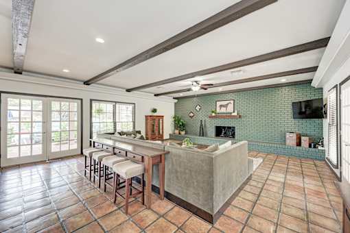 A kitchen with tile flooring and a large island.