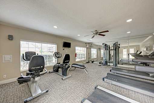 A spacious home gym with a variety of exercise equipment.