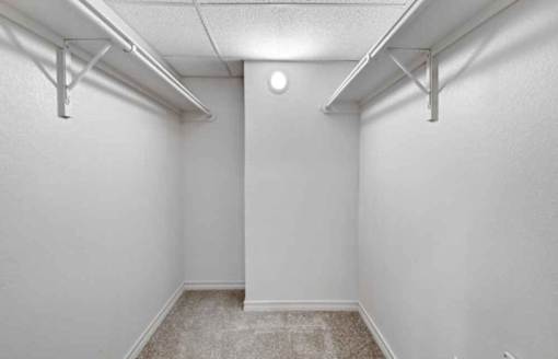 A white room with a carpeted floor and white walls.
