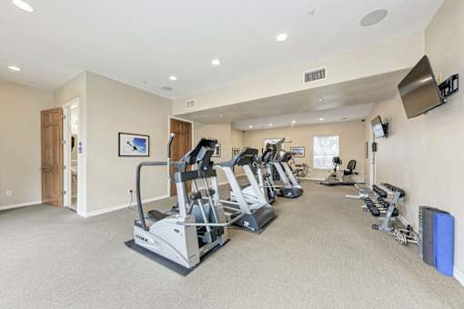 A spacious home gym with a variety of exercise equipment.