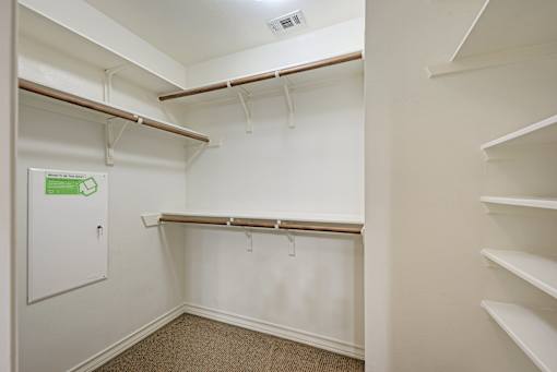 A white closet with a sign on the door.