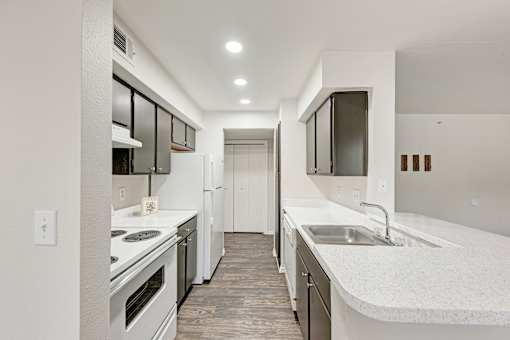 A kitchen with wooden cabinets and white appliances.